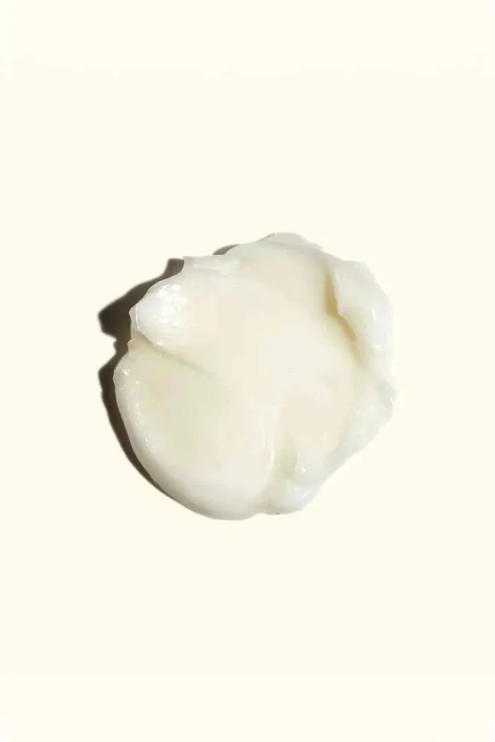 Rich, creamy texture swatch of Amika mask, infused with Jojoba Seed Oil for deep conditioning.
