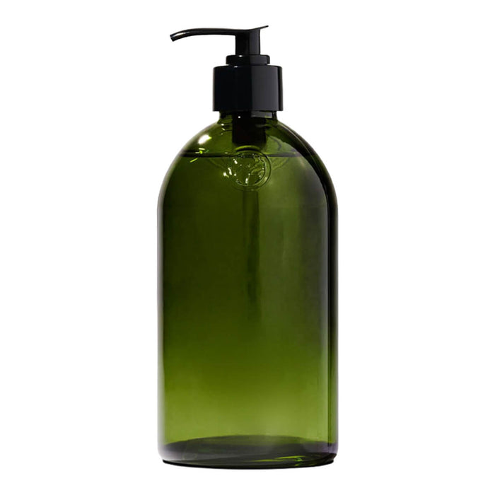Green apothecary glass bottle with a pump dispenser.