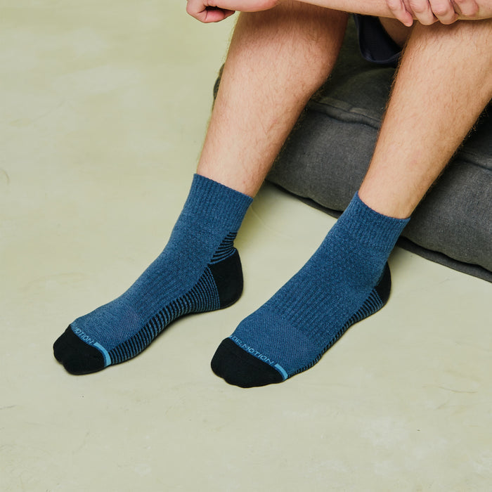 Quarter-length socks with ribbed cuffs, featuring a blue and black striped design.