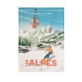 A tea towel with a printed design depicting a winter sports scene, titled 'LES ALPES' with a skier and mountains.