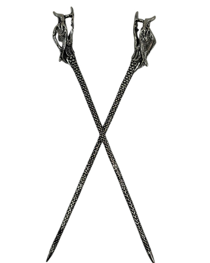 Silver textured metal Dragon Hair Sticks crossed in a front view on a white background.