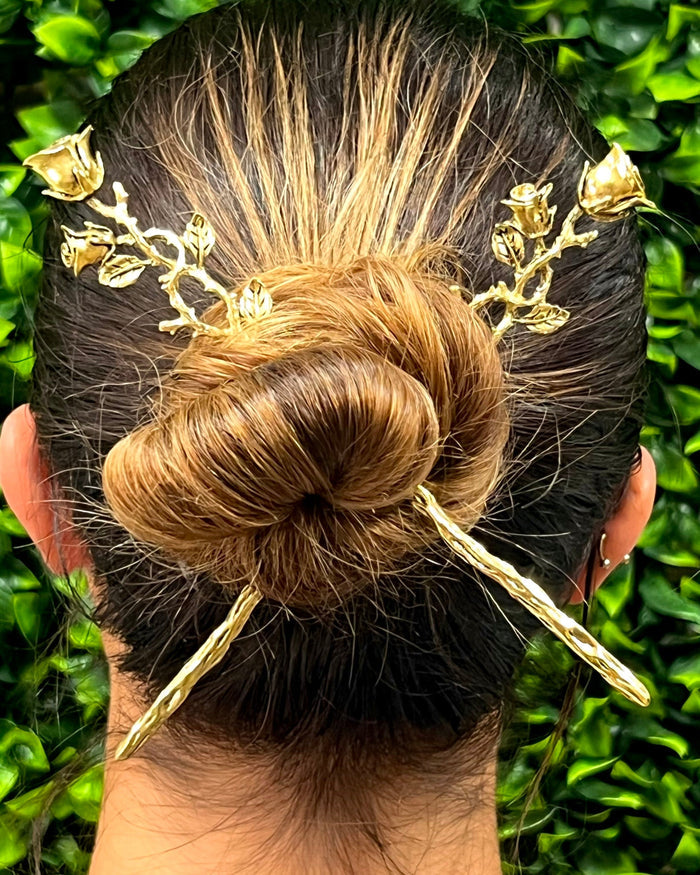 Model wearing gold Elegant Rose Vine Hair Sticks with detailed rose vine floral design in a bun hairstyle.