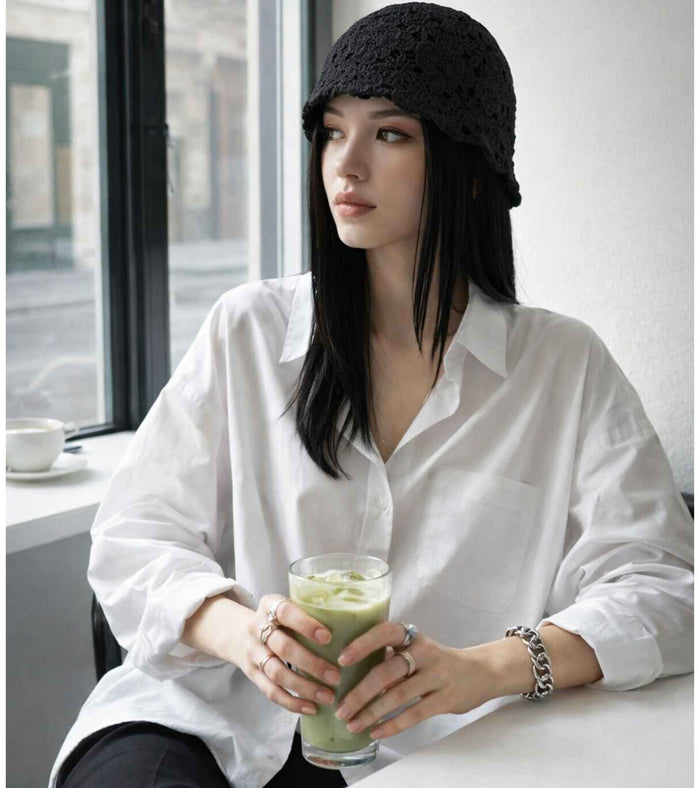 Black crochet lace bucket cap with dense open-knit texture and short brim