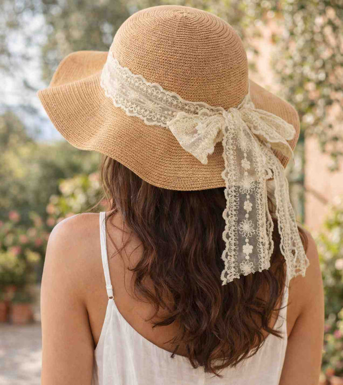 Sand straw sun hat with lace ribbon bow and long trailing ties, back view