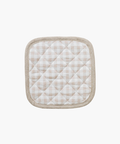 Quilted pot holder with a beige and white checkered pattern, framed by a light brown border. It has a soft, textured appearance, evoking coziness. | Wildwood Home Co.