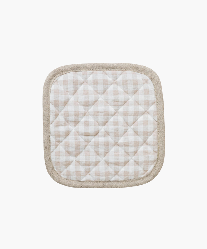 Quilted pot holder with a beige and white checkered pattern, framed by a light brown border. It has a soft, textured appearance, evoking coziness. | Wildwood Home Co.