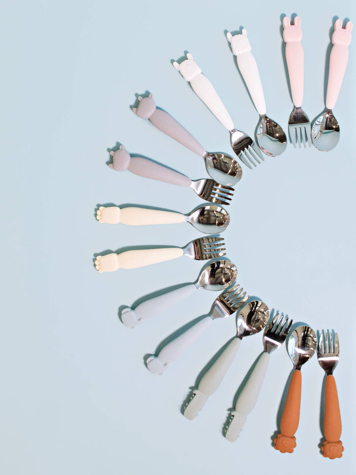 Set of colorful forks arranged in a circular pattern on a light blue background