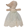 Stuffed animal toy with a lace dress on a white background