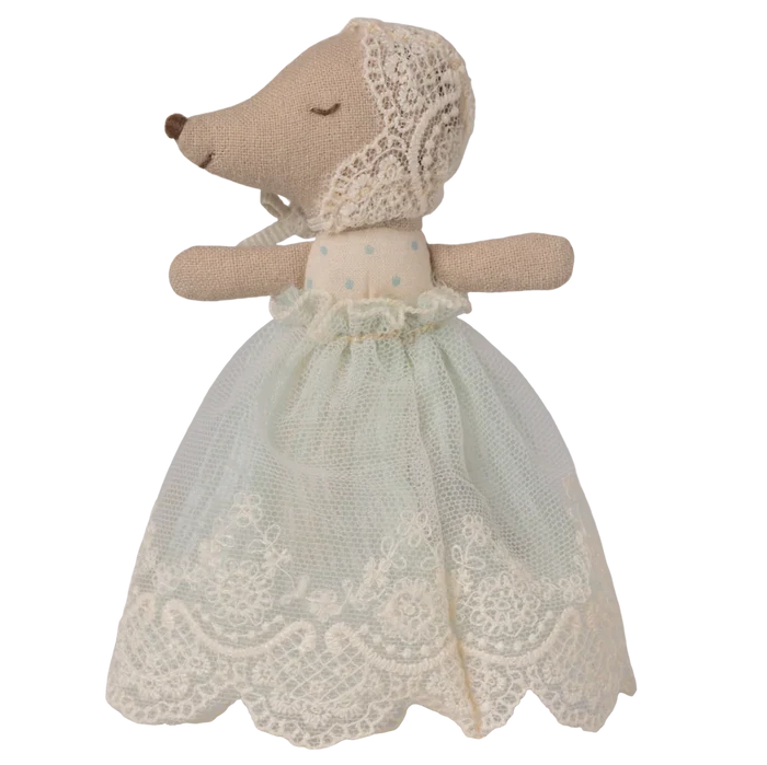 Stuffed animal toy with a lace dress on a white background