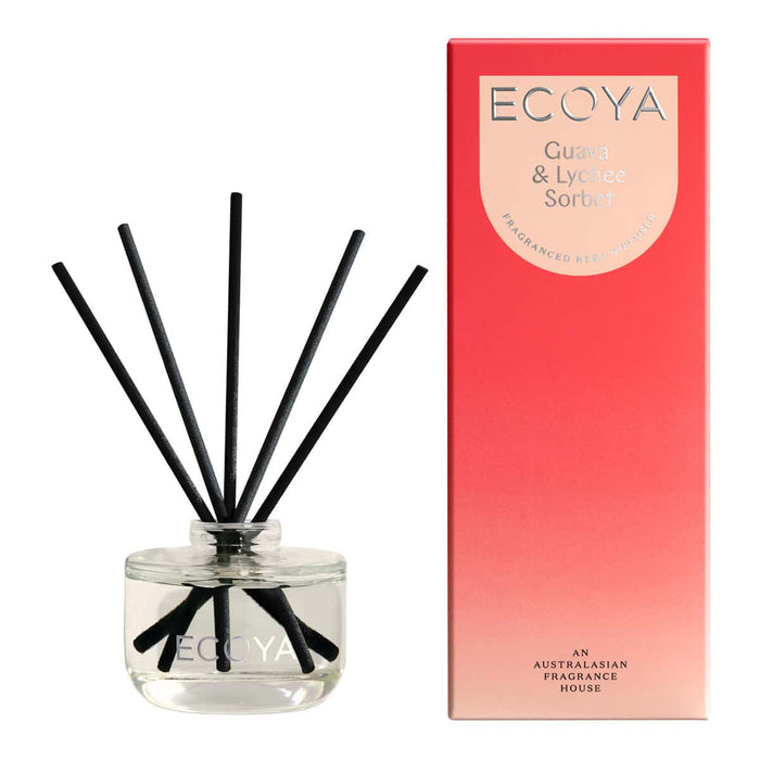 ECOYA mini reed diffuser - glass jar, next to red packaging. Guava & lychee sorbet fragrance.