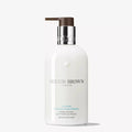 White bottle with pump and label on a white background