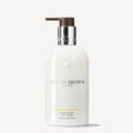 Molton Brown body lotion bottle on a white background