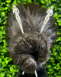 Model wearing silver Naked Lady Hair Sticks in a twisted bun hairstyle, showcasing unique artistic metal hair jewelry for women.