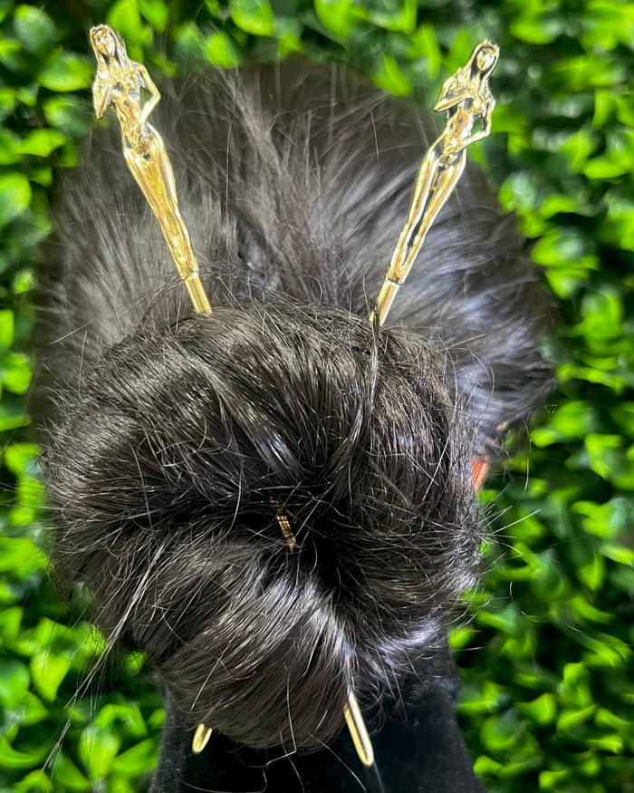 Model wearing Gold Naked Lady Hair Sticks securing a twisted bun hairstyle, elegant sculpted female figure hair jewelry for women.