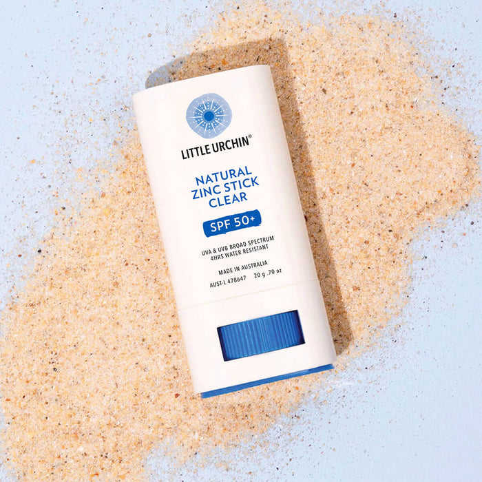 20g tube of Natural Zinc Stick SPF 50+ laying on sand.