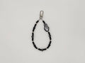Black beaded keychain wrist strap with skeleton hand peace sign charm and silver swivel clip.