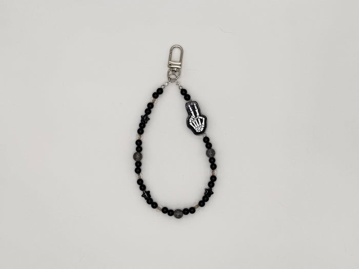 Black beaded keychain wrist strap with skeleton hand peace sign charm and silver swivel clip.
