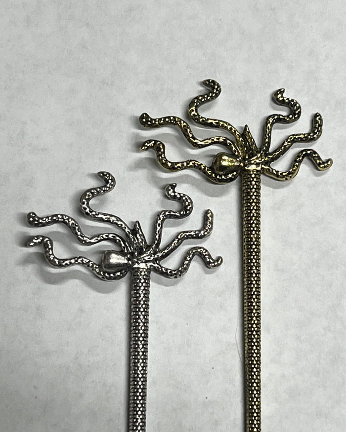 Pirate Squid Hair Sticks shown side by side in silver and gold finishes with octopus-inspired tentacle design.