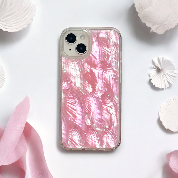 Pink real natural shell phone case on an iPhone, displayed with white and pink decorative fabric and paper accents.