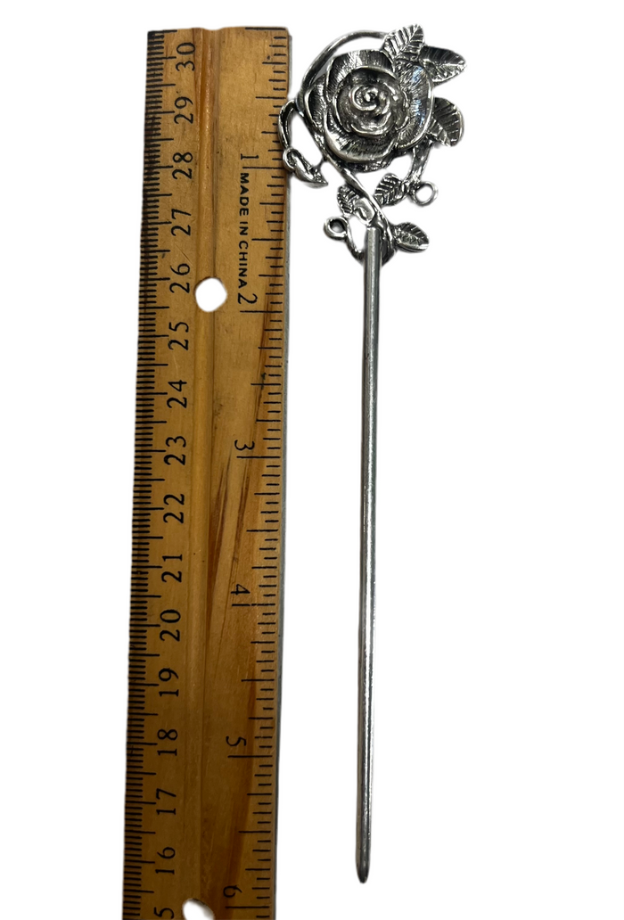 Silver rose hair stick with elegant floral vine design shown next to a ruler for size reference on a white background.
