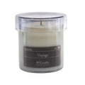 Candle in a clear container labeled 'Voyage' on a white background