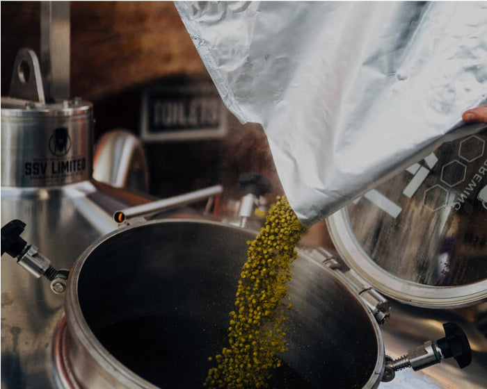 Pouring ingredients into a brewing kit