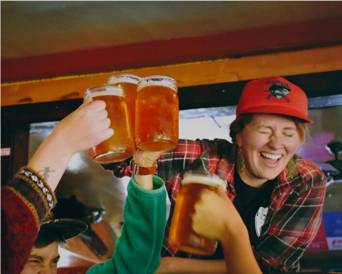 A group of people toasting with steins of beer