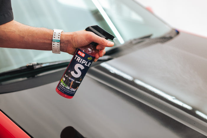 Person spraying P&S Triple S onto the hood of a car.