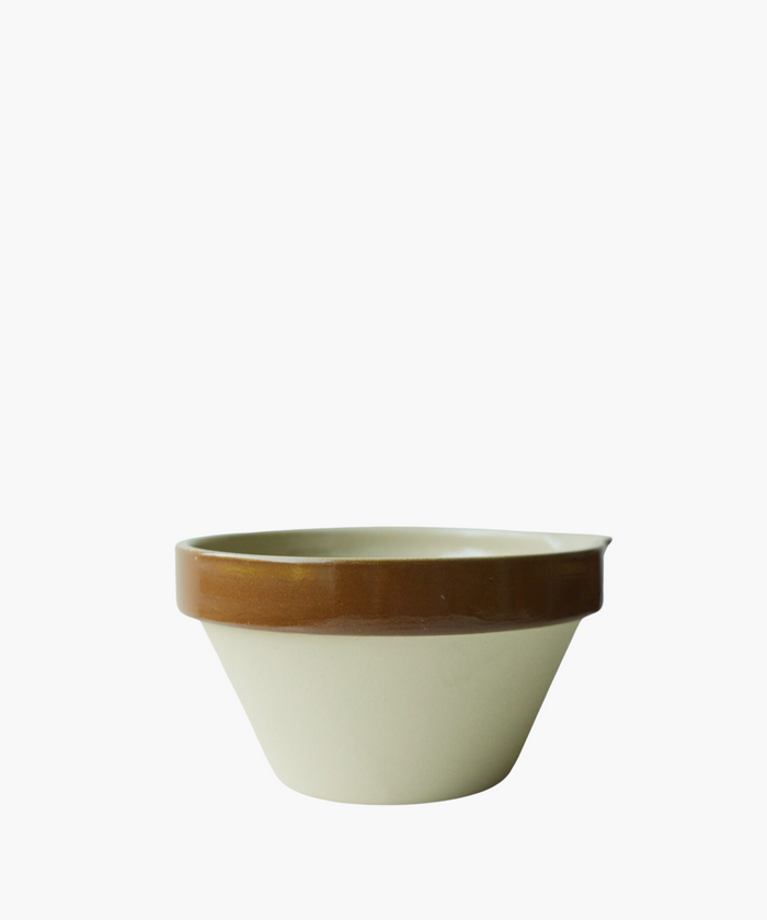A ceramic bowl with a beige base and a glossy brown rim. The simple and functional design conveys a rustic and practical tone. | Wildwood Home Co.