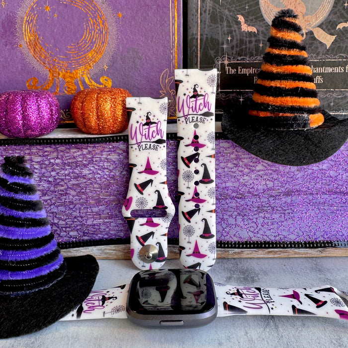 Witch Please silicone Fitbit Versa 1/2 band hero shot in cream with purple witch hats and spiderwebs, shown with a black Fitbit Versa.